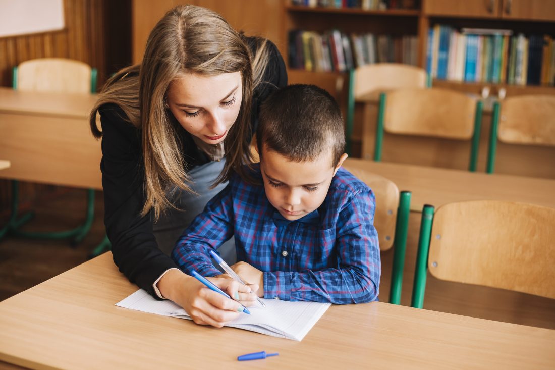 A girl teaches english to a child abroad as a means to earning money abroad. 